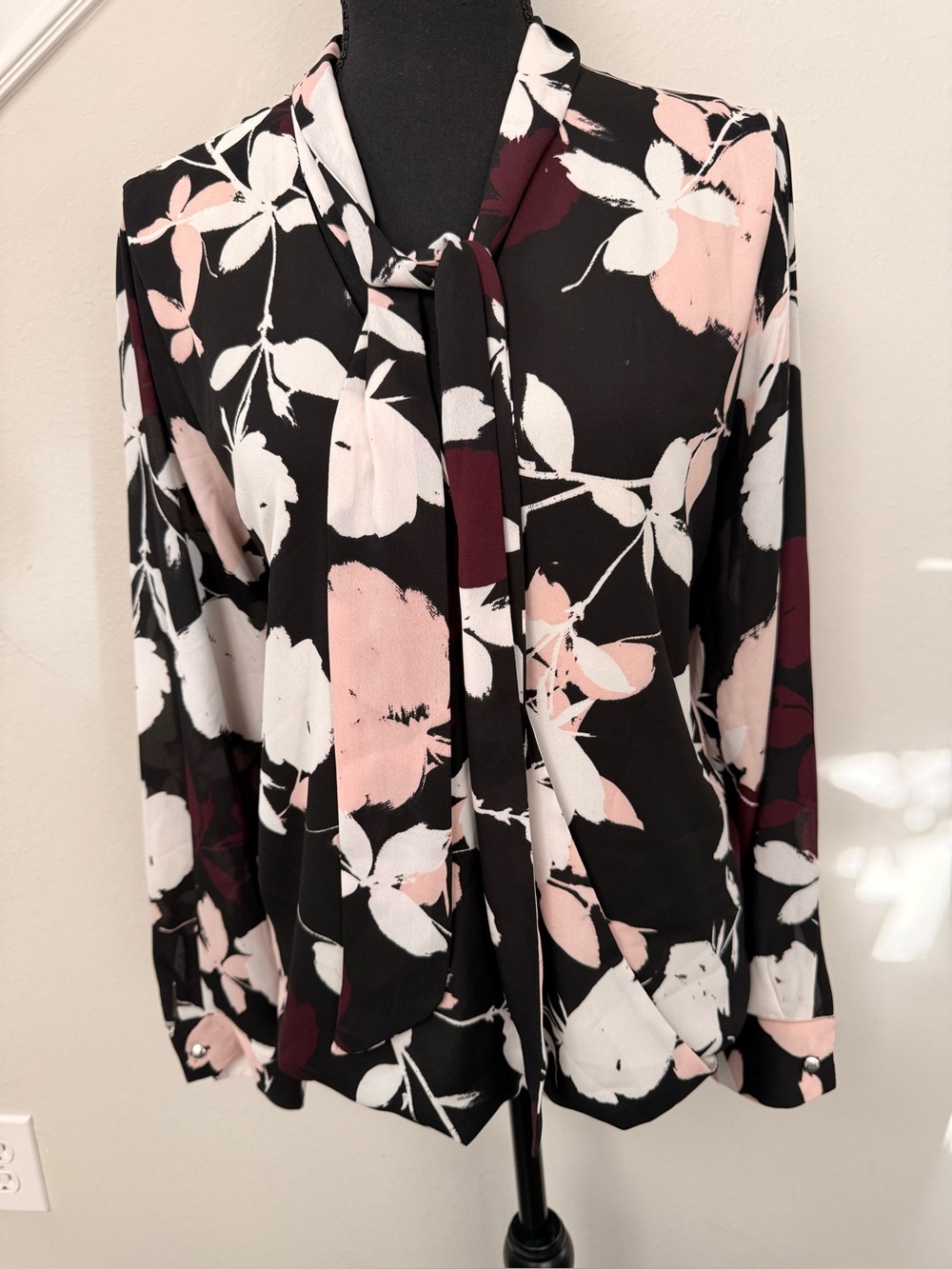 Vince Camuto’s Black Floral Tie-Neck Blouse with Pink and White Accents